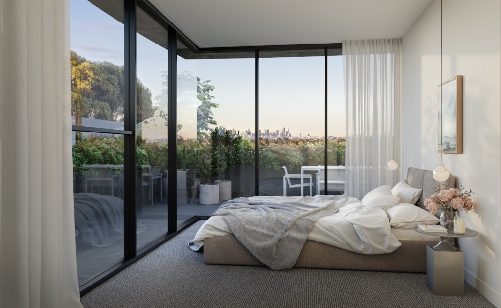 Wool carpeting and ample natural light travels through floor-to-ceiling bedroom windows